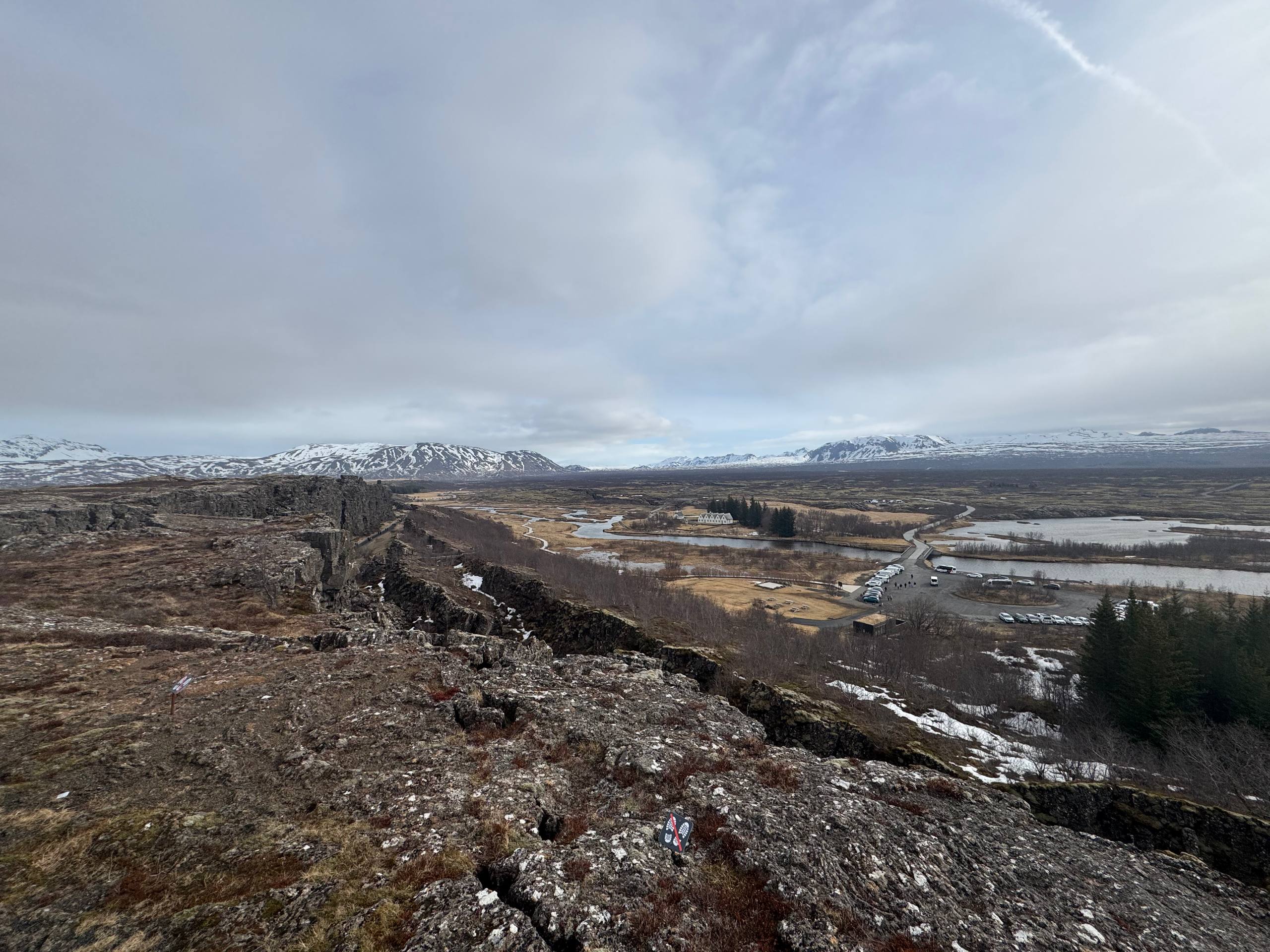 Iconic Almannagjá rift valley with rocky cliffs and distant mountains captured during a Day Trips From Reykjavik guided tour with our agency