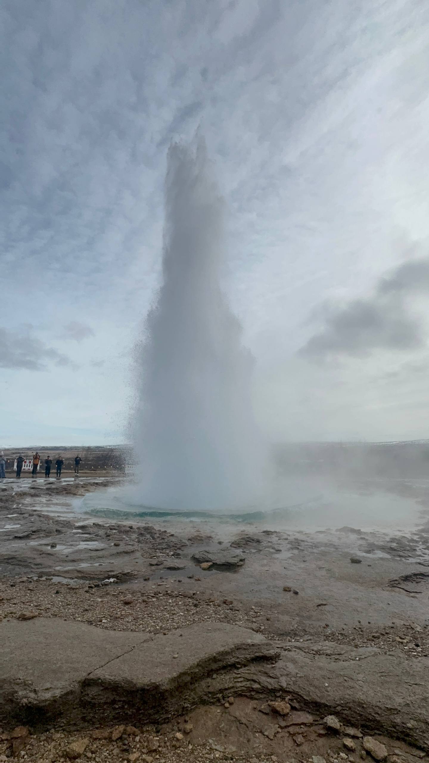 Strokkur Geyser erupting with a powerful burst of hot water and steam in Iceland’s geothermal area during a Day Trips From Reykjavik tour with our agency