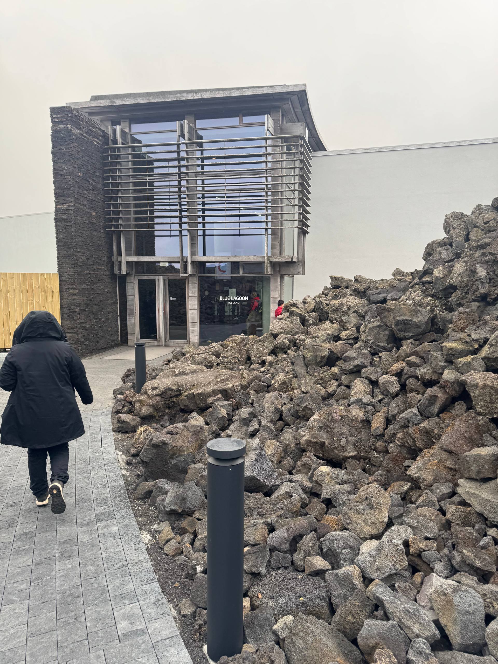 Blue Lagoon Iceland entrance building with glass facade and rugged lava rocks captured during a Day Trips From Reykjavik guided tour with our agency