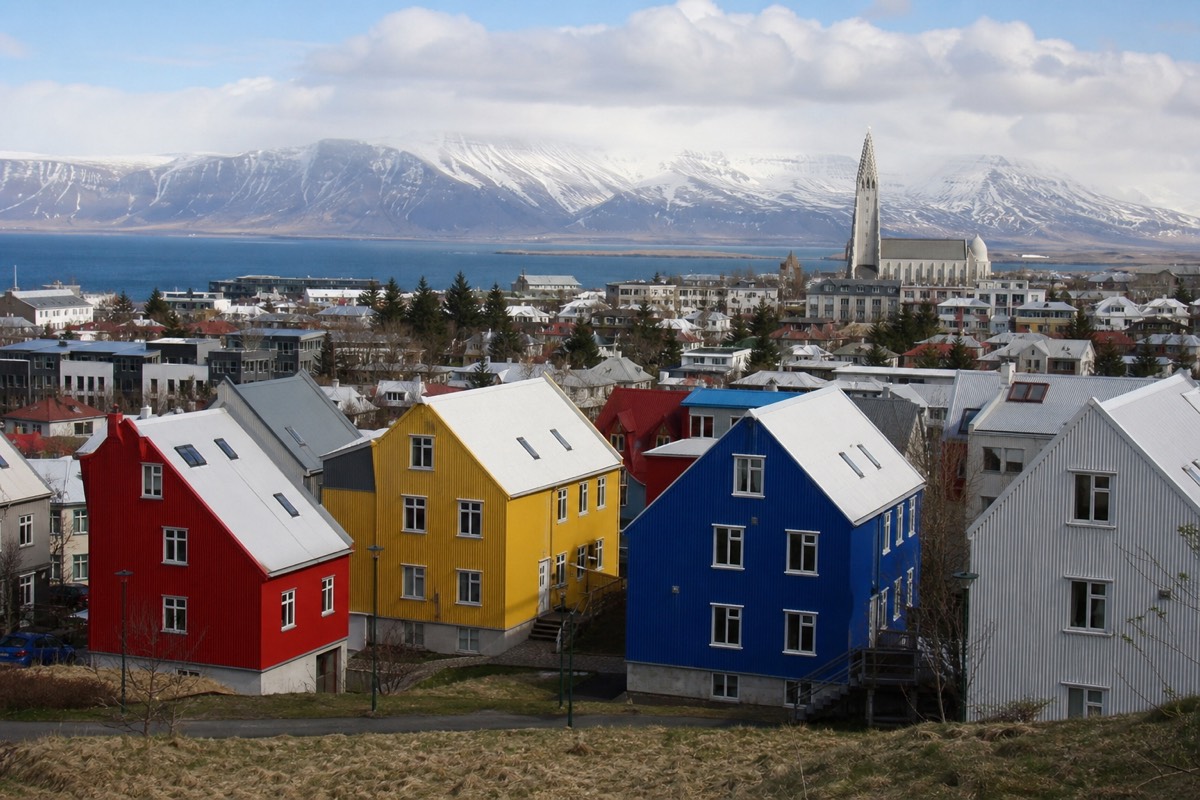 Reykjavik rooftops and harbour with mountains across the bay on a clear day