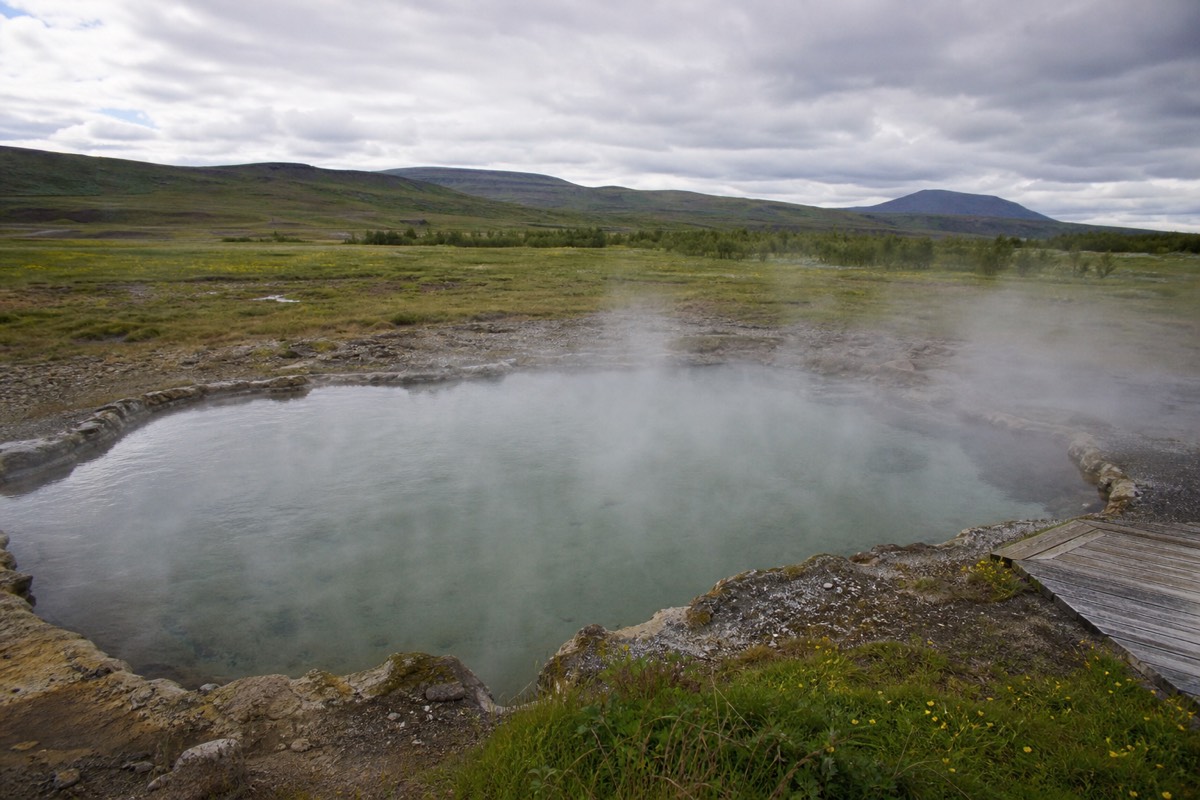 Steam drifting across the Secret Lagoon hot spring pool at Fludir in south Iceland