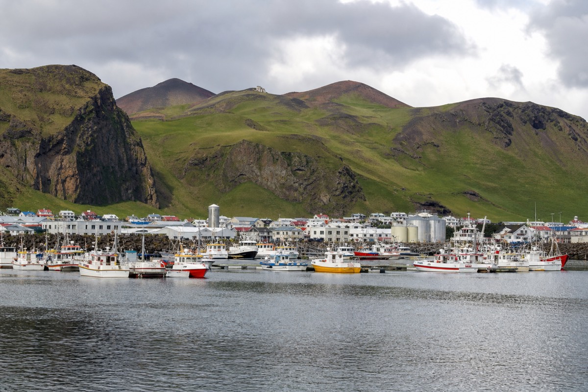 Heimaey harbour in the Westman Islands with the Eldfell volcanic cone behind the town